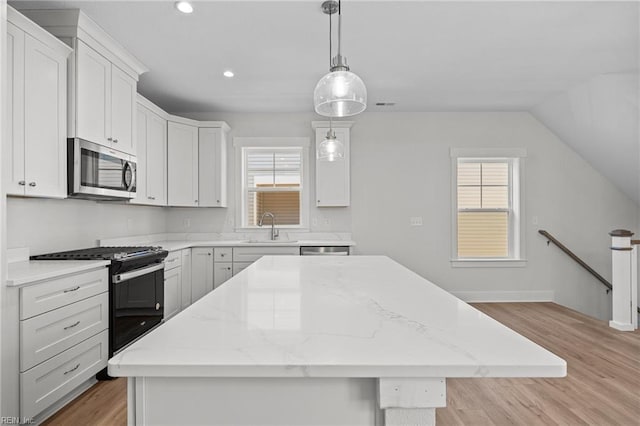 kitchen featuring white cabinetry, pendant lighting, stainless steel appliances, and a center island