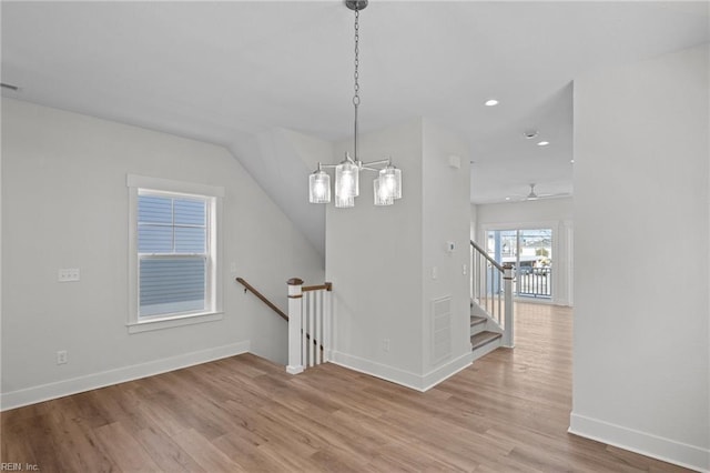 stairs featuring hardwood / wood-style floors