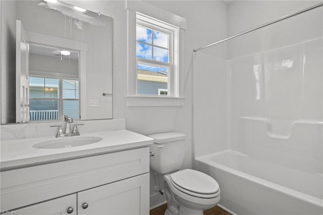 full bathroom with a healthy amount of sunlight, toilet, bathing tub / shower combination, and vanity