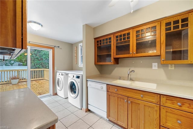 kitchen with sink, light tile patterned floors, dishwasher, ceiling fan, and washer and clothes dryer