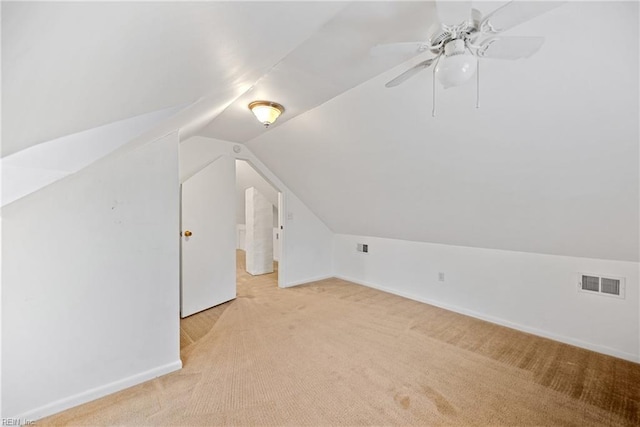 additional living space featuring lofted ceiling, light colored carpet, and ceiling fan