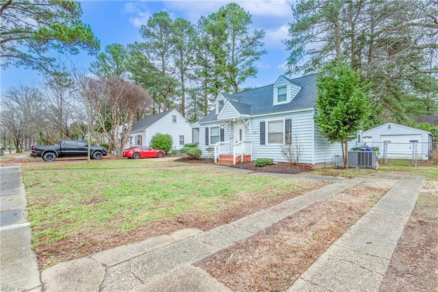 cape cod house with central AC unit and a front lawn