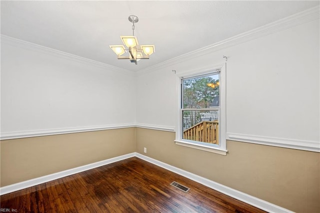 unfurnished room with crown molding, wood-type flooring, and a chandelier