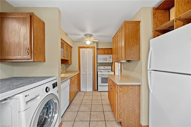 kitchen featuring washer / clothes dryer, sink, light tile patterned floors, ceiling fan, and white appliances