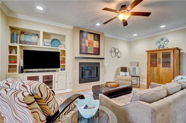 living room featuring ornamental molding, ceiling fan, and built in shelves