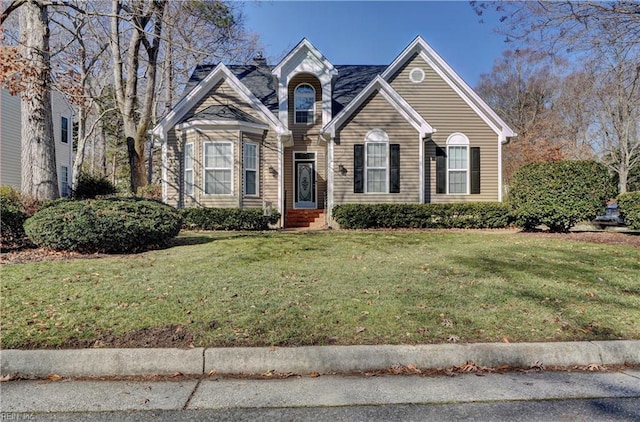 view of property featuring a front lawn