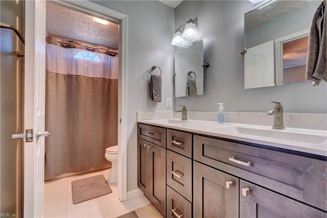 bathroom with vanity, tile patterned floors, a textured ceiling, and toilet