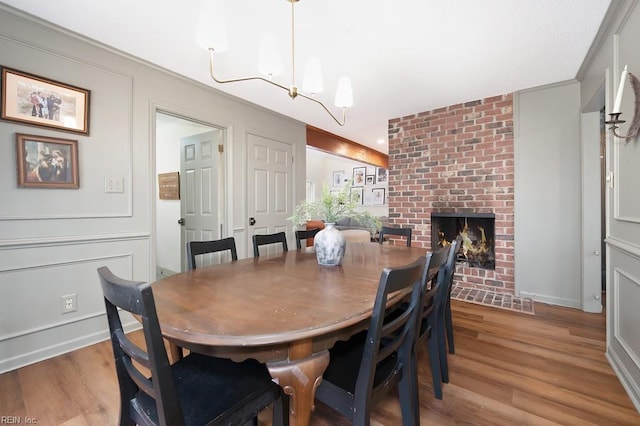 dining area with a fireplace and light hardwood / wood-style flooring