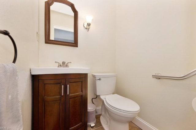 bathroom with vanity, tile patterned floors, and toilet