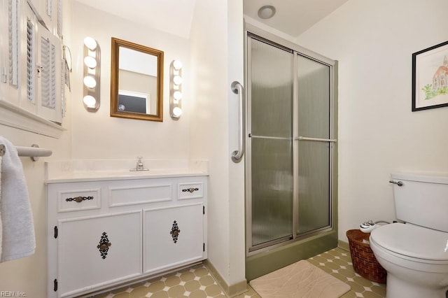 bathroom featuring vanity, toilet, and walk in shower