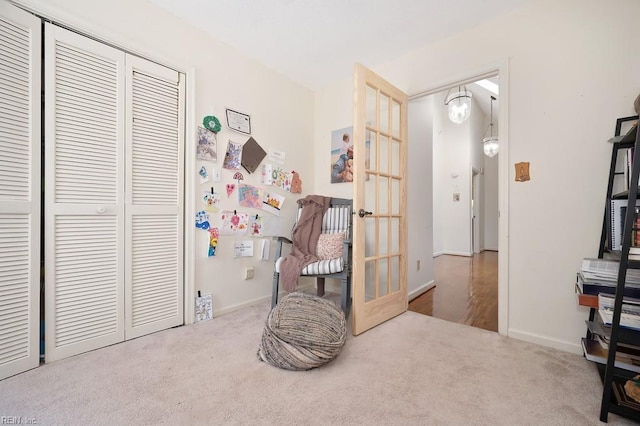 carpeted bedroom with a closet and french doors