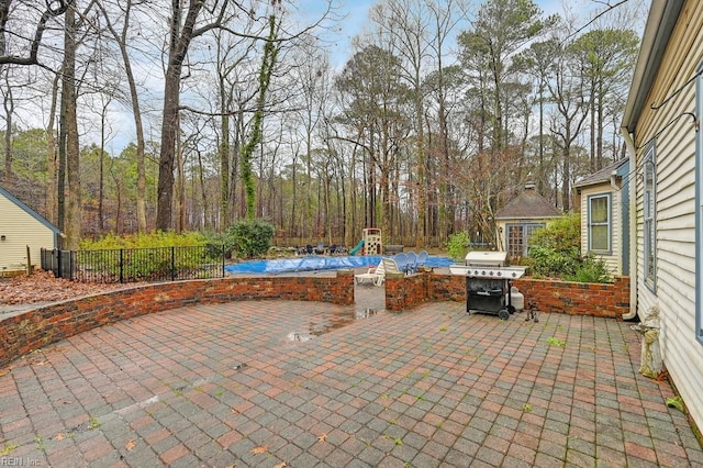 view of patio / terrace featuring area for grilling and a playground