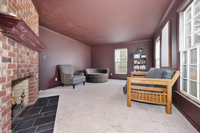 living area with crown molding, carpet, a textured ceiling, and a fireplace