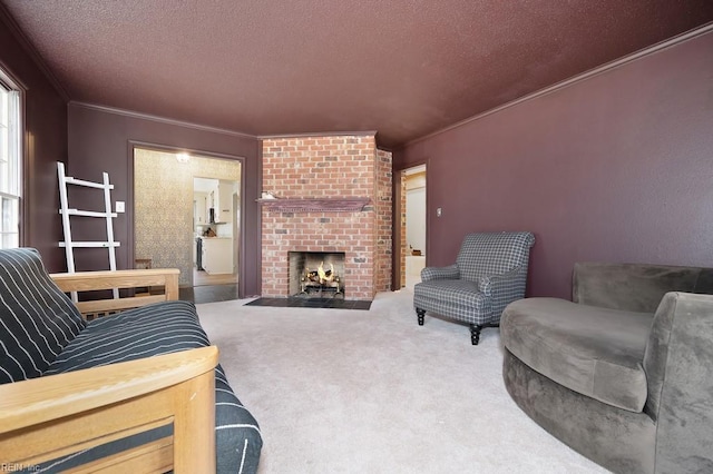 carpeted living room featuring a fireplace, ornamental molding, and a textured ceiling