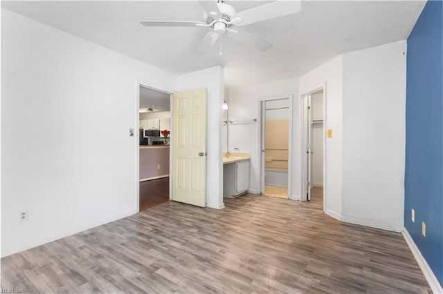 107 Marshall Way Unit J, Williamsburg, VA 23185 - unfurnished bedroom featuring wood finished floors, baseboards, connected bathroom, and ceiling fan