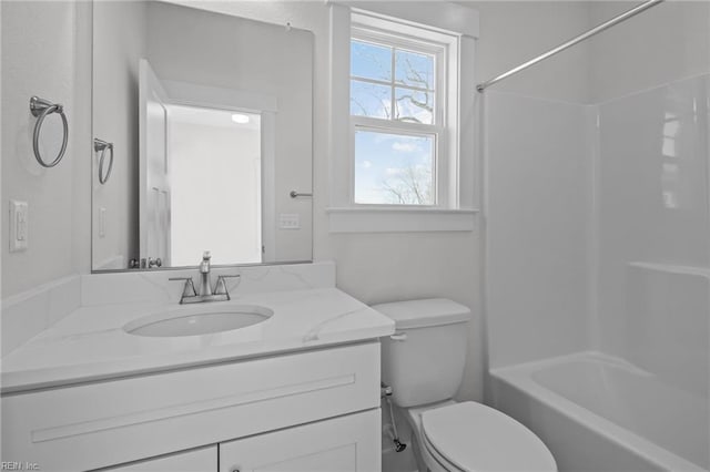 full bathroom with vanity, shower / tub combination, and toilet