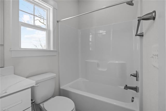 full bathroom featuring vanity, washtub / shower combination, and toilet