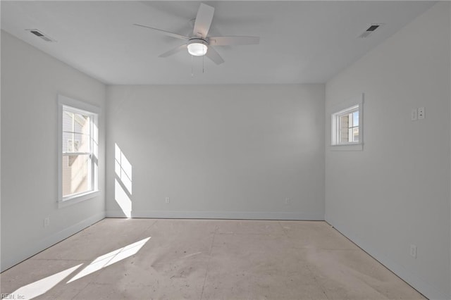 spare room featuring ceiling fan and a wealth of natural light