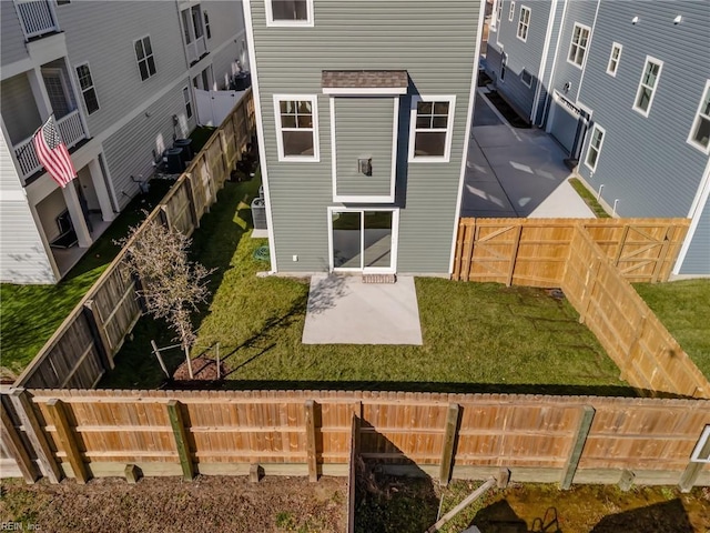 rear view of house with a yard and a patio