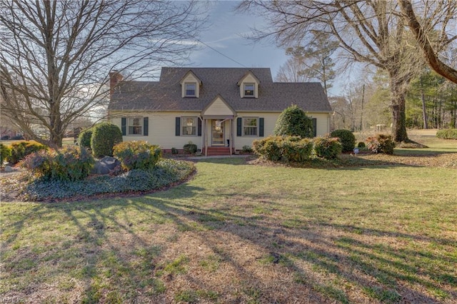 cape cod-style house featuring a front lawn