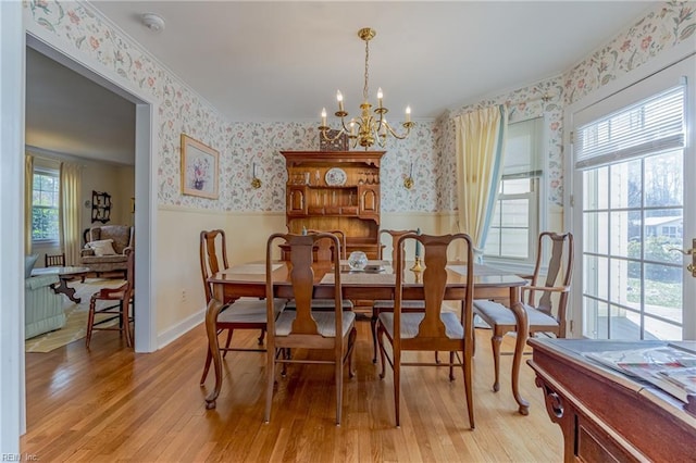 dining area featuring a notable chandelier and light hardwood / wood-style floors