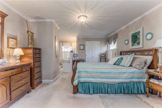 bedroom with crown molding, ensuite bath, and light carpet