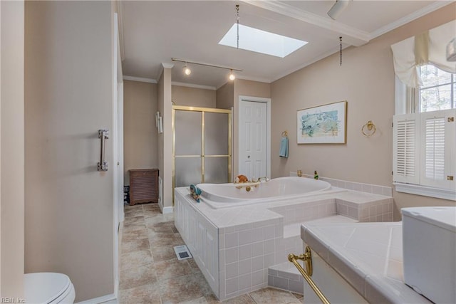 bathroom featuring a relaxing tiled tub, ornamental molding, toilet, and a skylight