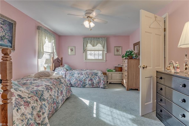 bedroom featuring ceiling fan and light carpet