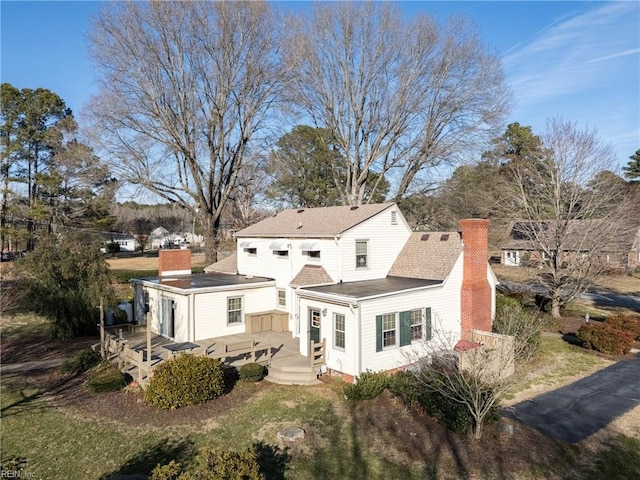 rear view of property featuring a deck