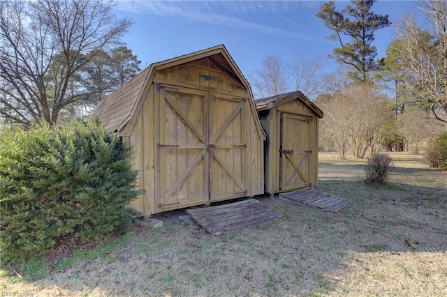 view of outbuilding with a lawn