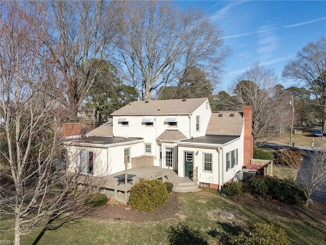 back of house with a wooden deck and a yard