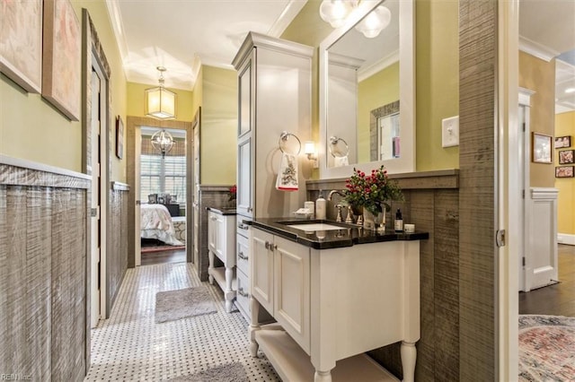 bathroom with ornamental molding and vanity