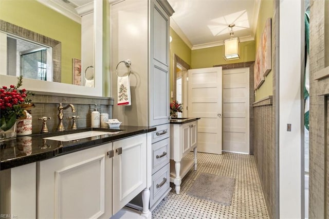 bathroom featuring vanity, backsplash, and crown molding