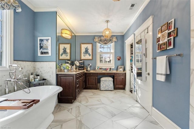 bathroom featuring vanity, ornamental molding, and a tub