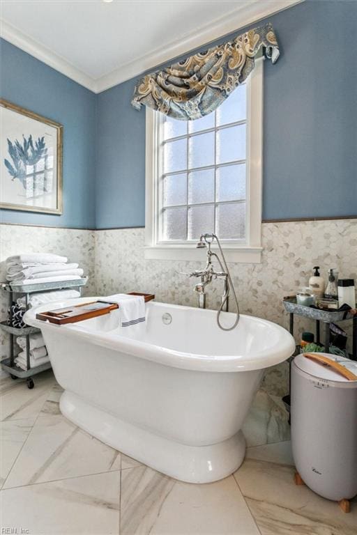 bathroom with crown molding and a bathtub