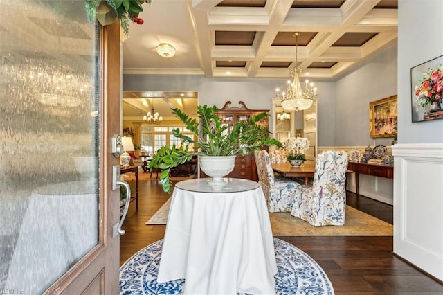 dining room with coffered ceiling, dark wood-type flooring, beamed ceiling, and a chandelier