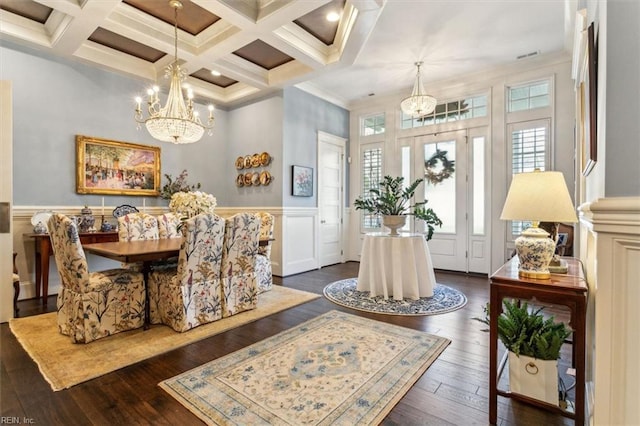 dining area with an inviting chandelier, coffered ceiling, dark hardwood / wood-style floors, and beamed ceiling