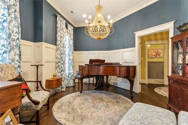 sitting room featuring an inviting chandelier, crown molding, and dark hardwood / wood-style flooring