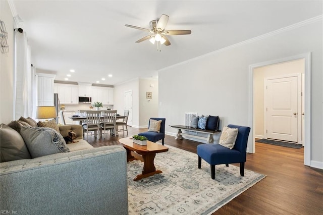 living room featuring crown molding, hardwood / wood-style flooring, and ceiling fan