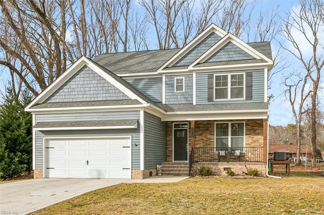 craftsman house with cooling unit, a porch, a garage, and a front yard