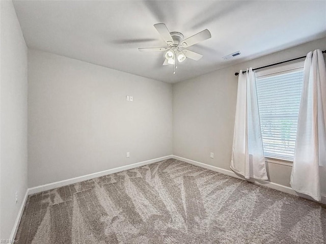 carpeted spare room featuring ceiling fan