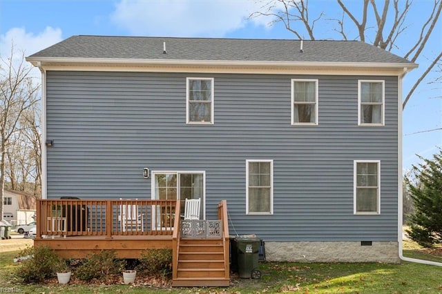 rear view of house with a deck and a lawn