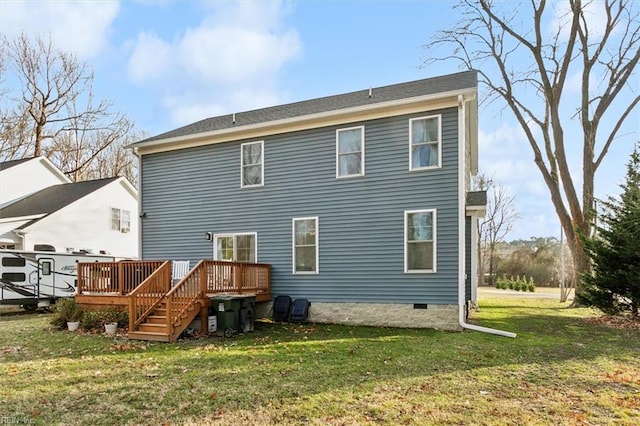 rear view of house featuring a lawn and a deck