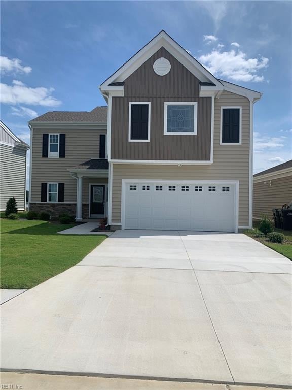 view of front of home featuring a garage and a front yard