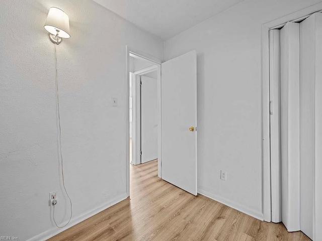 bedroom featuring a closet and light hardwood / wood-style flooring