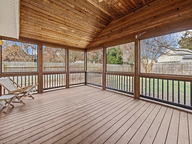 unfurnished sunroom with lofted ceiling, a wealth of natural light, and wooden ceiling