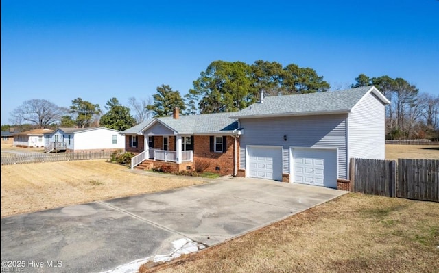 view of front of home featuring a garage, a front yard, and a porch