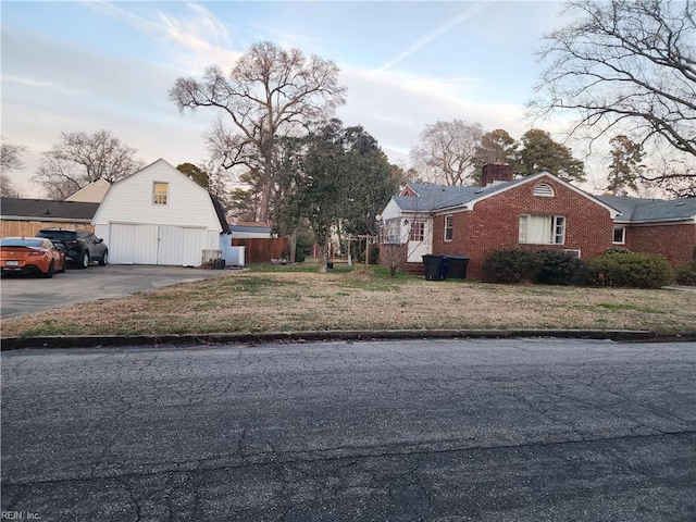 property exterior at dusk with a garage and a lawn