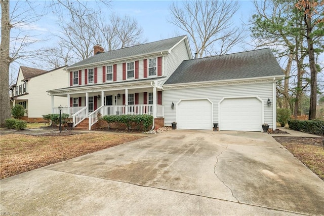 colonial house with a garage and covered porch