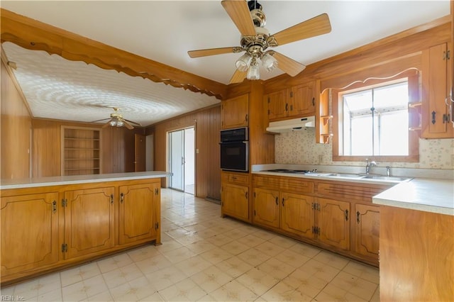 kitchen with sink, built in features, ceiling fan, white gas cooktop, and oven